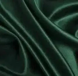 Close-up of luxurious emerald green plain silk fabric with smooth, shiny texture