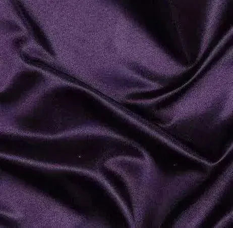 Close-up of smooth, dark purple plain silk fabric with soft folds and sheen