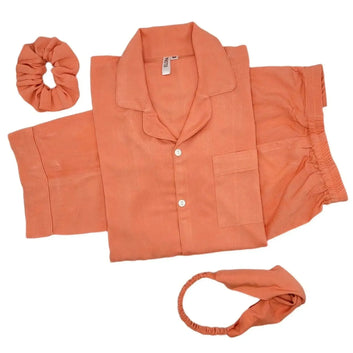 Solid peach linen pajama set with button-up shirt, shorts, scrunchie, and headband