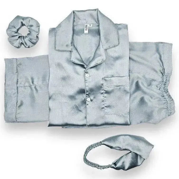 Light blue solid silk pajama set with button-up shirt, shorts, matching scrunchie, and headband